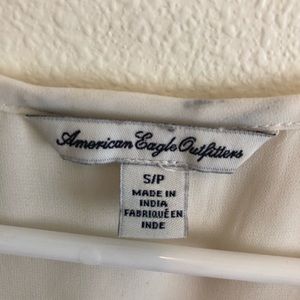 White shirt with silver metal buttons